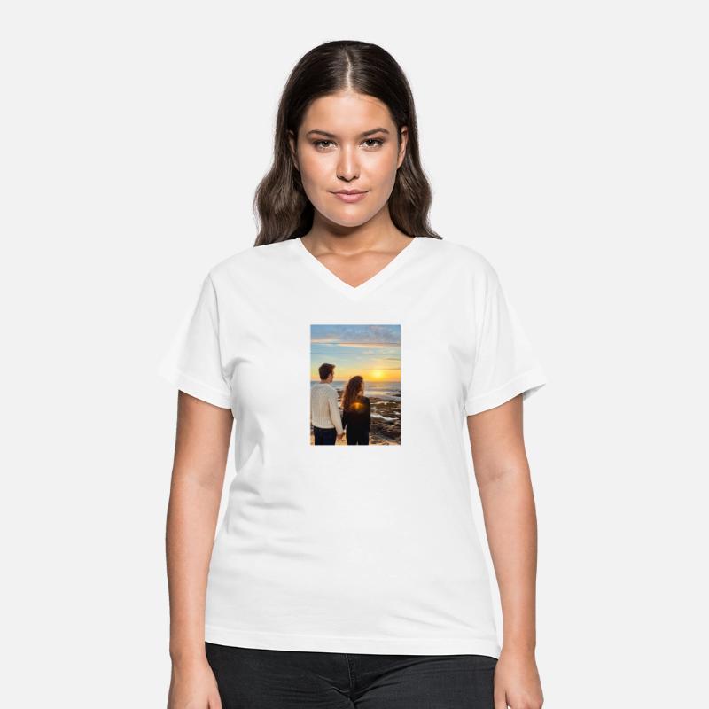 Couple Hand In Hand On Sandy Beach At Sunset